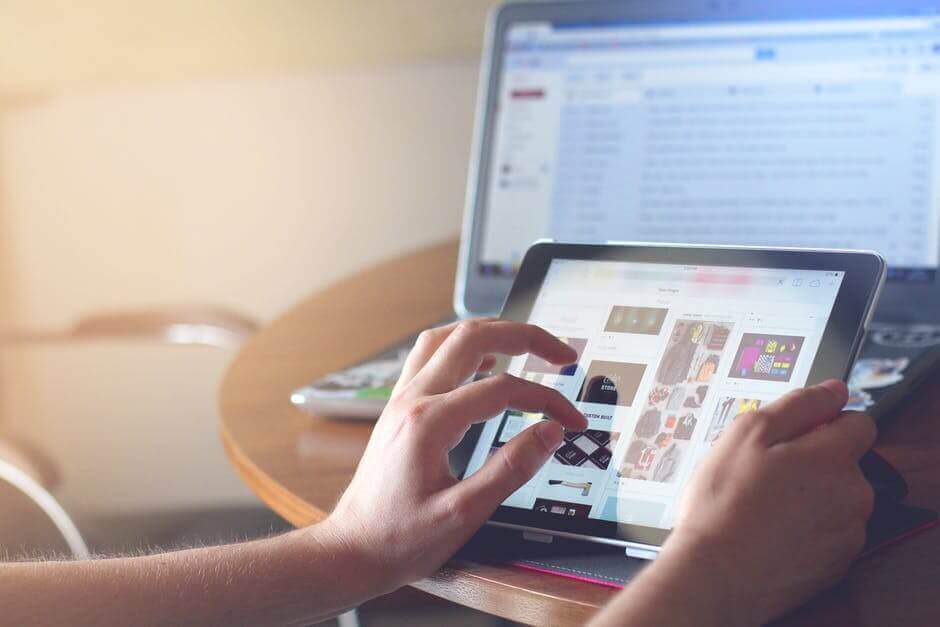 A person tapping on an iPad